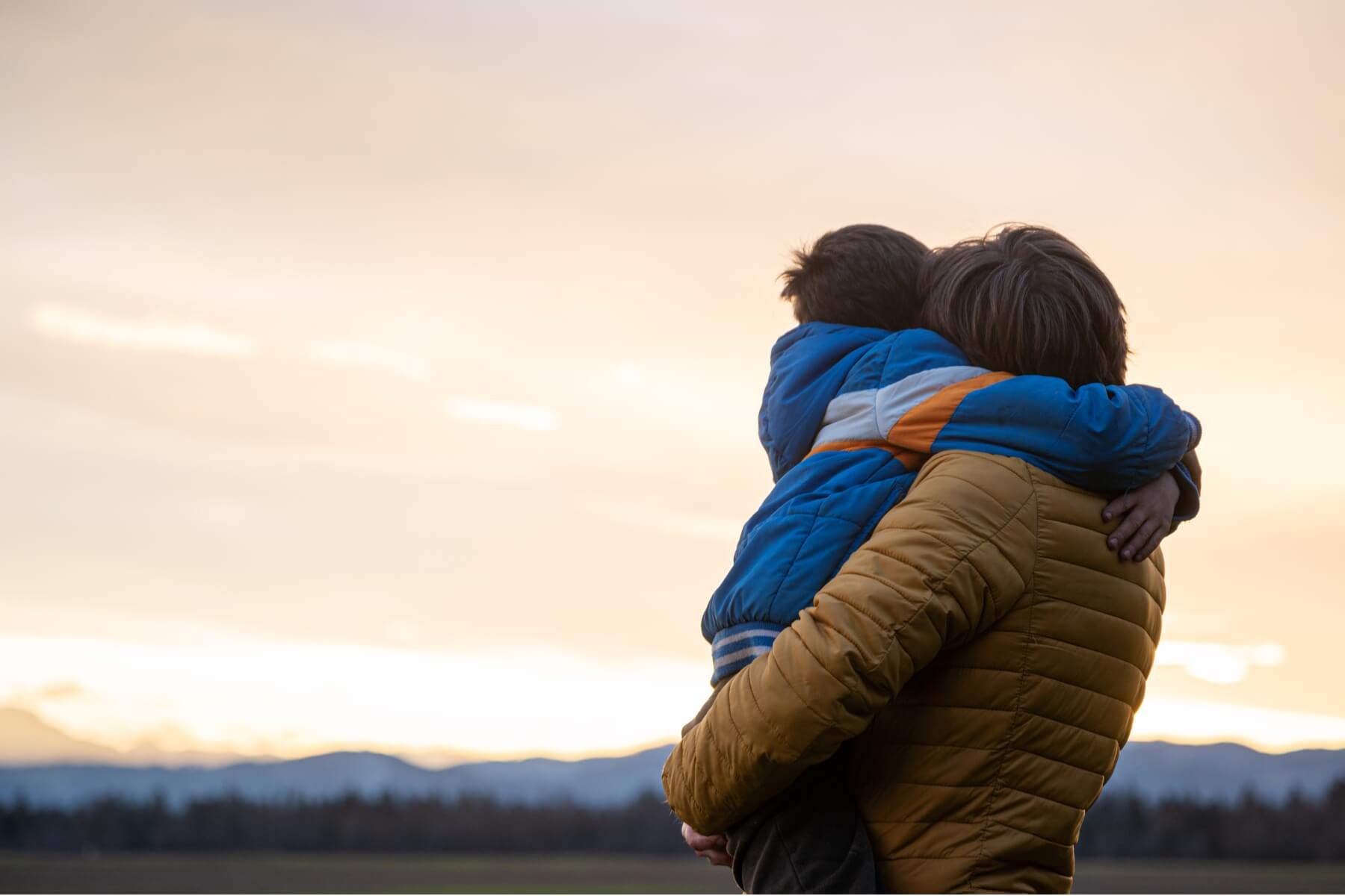 Father embracing his child after reunification